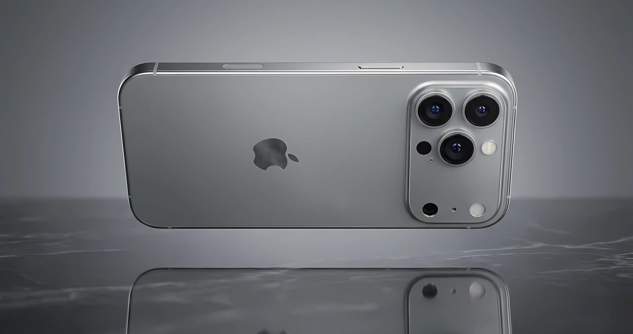 هاتف آيفون iPhone 18 Pro باللون الرمادي وتصميم الكاميرا الدائرية الممركزة بحجم مكبر فوق خلفية رمادية فضية سادة